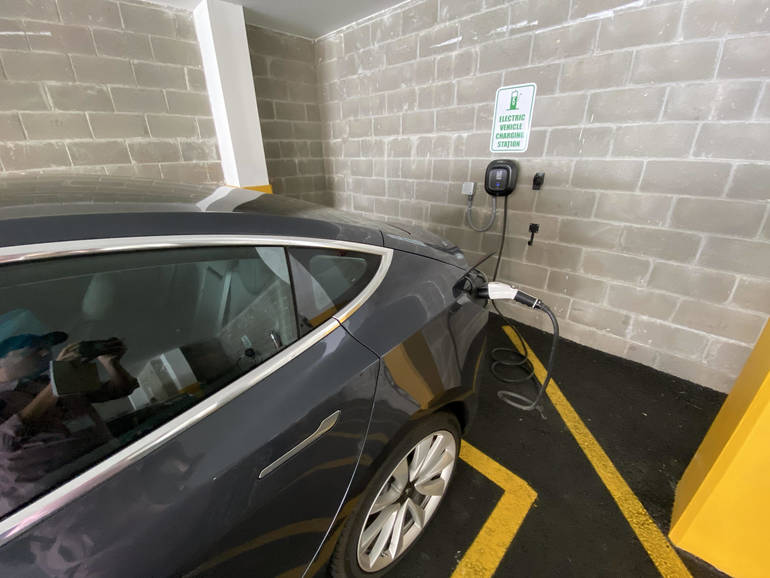 An electric vehicle is plugged into a charging station