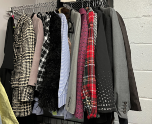 Jackets and shirts in different styles range on a rack